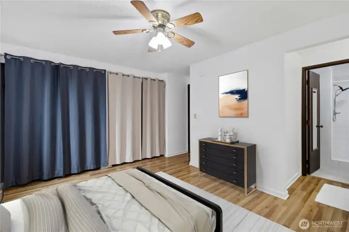 Virtually staged primary bedroom notices the ensuited bathroom.