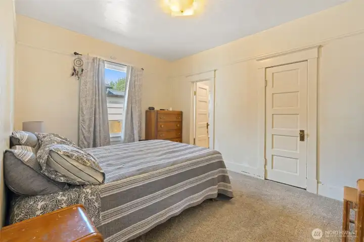 Primary bedroom with doors to the living room and bathroom.