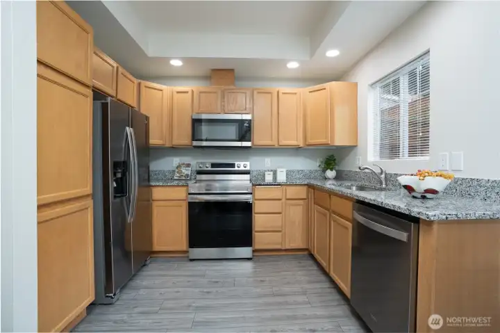 The kitchen is equipped with all stainless steel appliances, offering a sleek, modern look and everyday functionality.