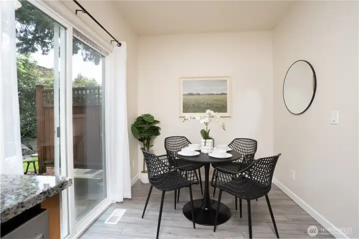 The dining area features a sliding glass door that opens to the patio, creating an easy flow for indoor-outdoor living.