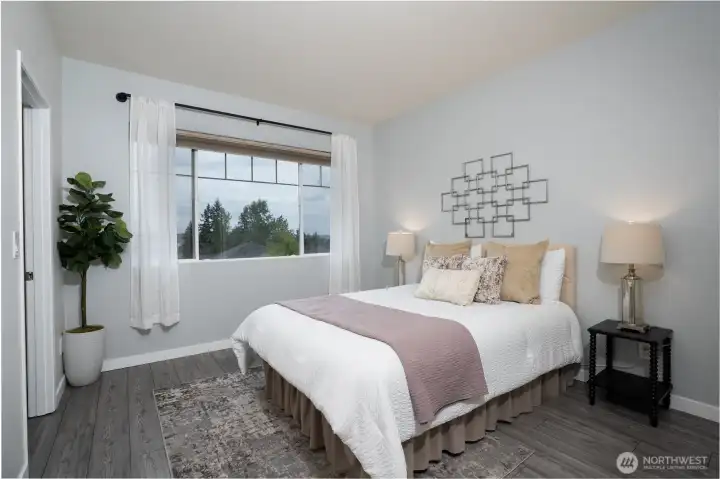 The primary bedroom offers a comfortable retreat with ample space, natural light, and a peaceful atmosphere for rest and relaxation.