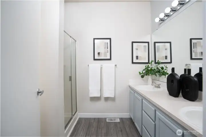 The primary bathroom includes a walk-in shower, offering a clean, modern, and convenient space to start and end your day.