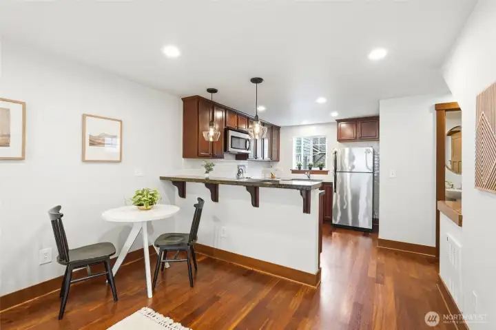 Kitchen has breakfast bar and space for a dining table