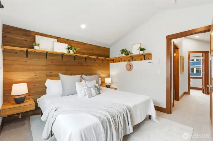 Main bedroom features built in shelving, nightstands and closet organizer