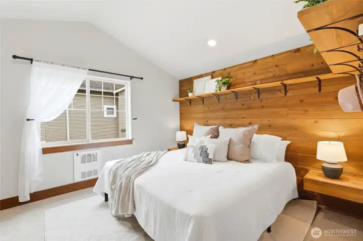 Main bedroom features built in shelving, nightstands and closet organizer