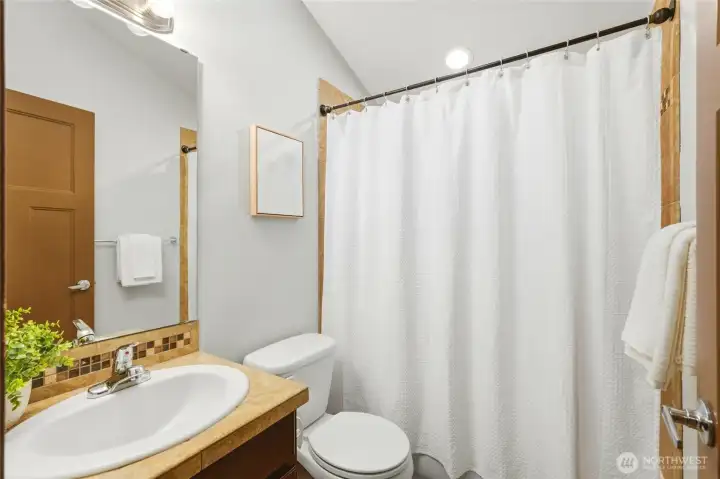 Full bathroom on upper level with skylight