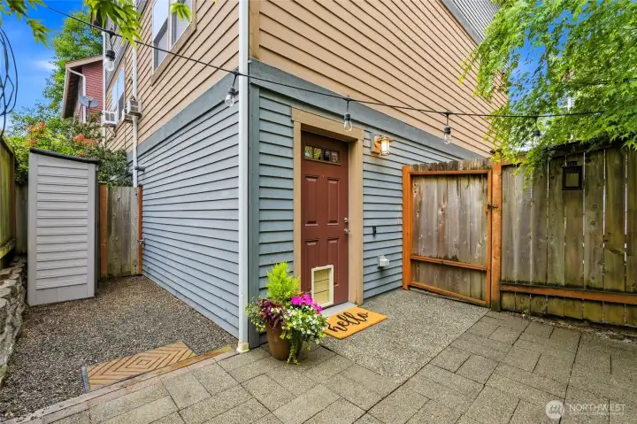 Front door acces behind gate, creates private setting. Courtyard has small storage shed.