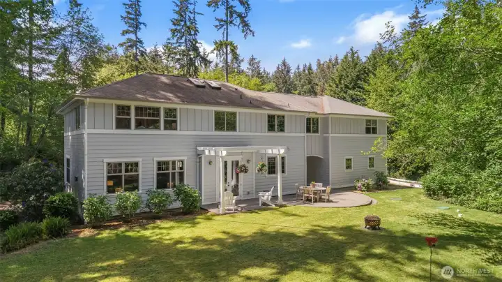 A peaceful backyard retreat surrounded by towering evergreens and exceptional privacy.