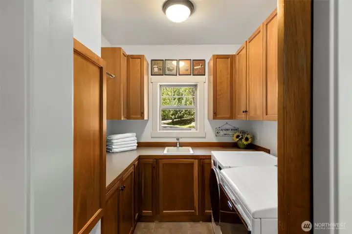 Laundry room with ample storage.