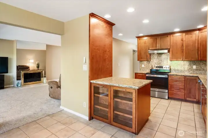 Additional view of the dining room with glimpses of the kitchen and living room.