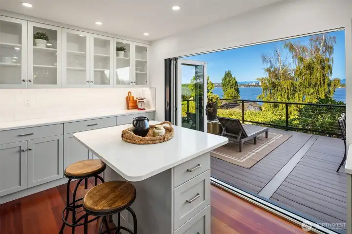 Kitchen opens to expansive deck Kitchen opens to expansive deck