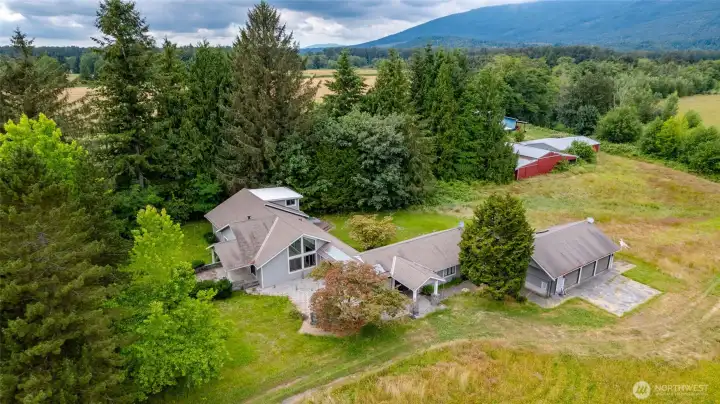 Aerial of the home, barns and towards the river.