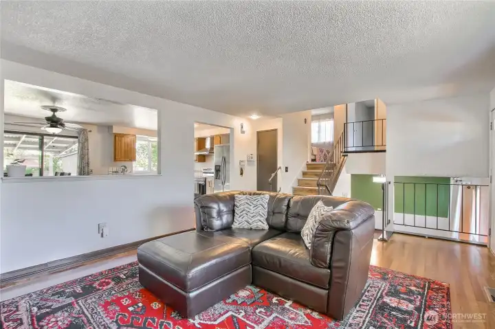 Open living space connects easily to the kitchen and upper level.