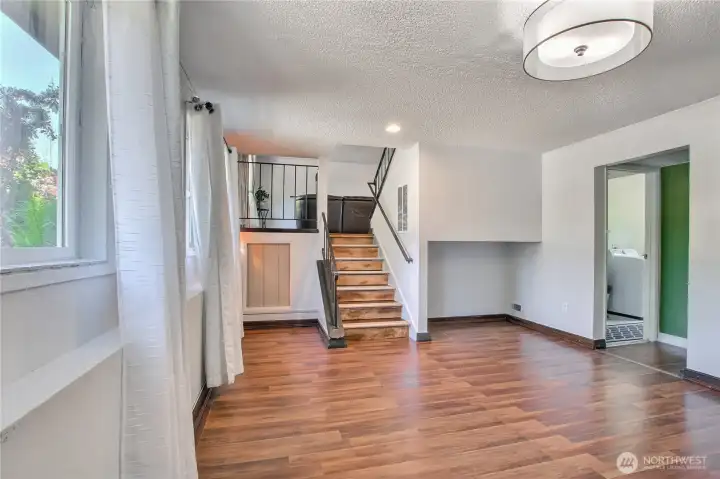Open layout with staircase and easy access to laundry area.