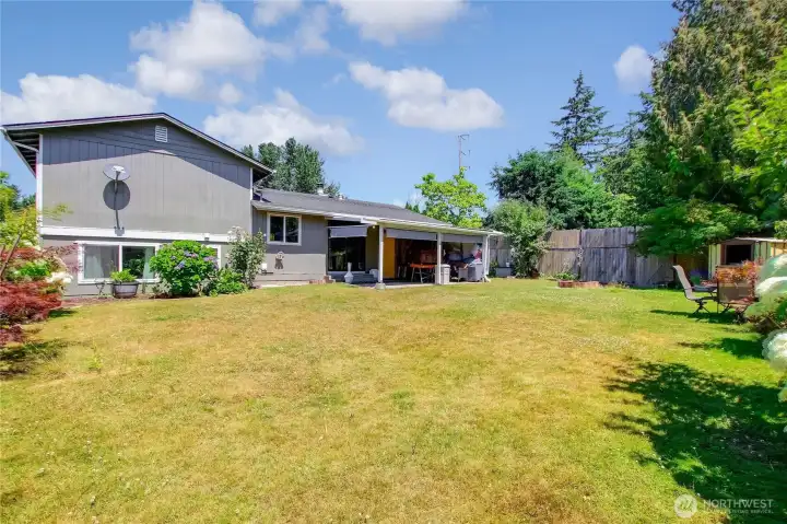 Generous lawn space with covered patio access.
