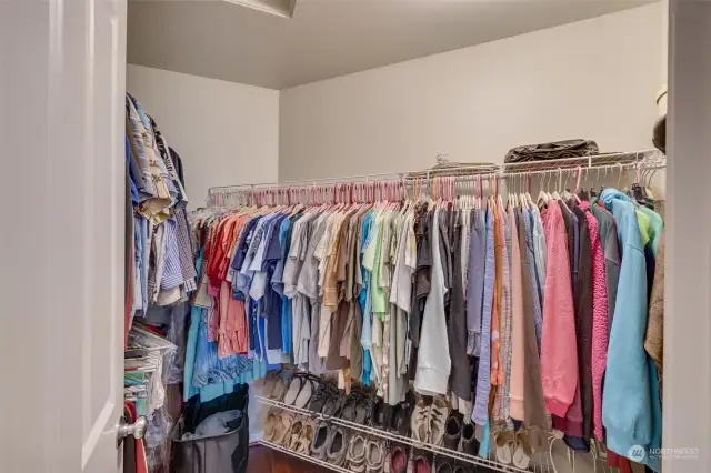 Primary walk-in closet has plenty of room for his and her clothing.