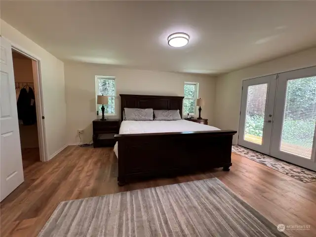 This is a very spacious room with French doors out to the back deck. The doors have built-in mini blinds sandwiched between the glass.