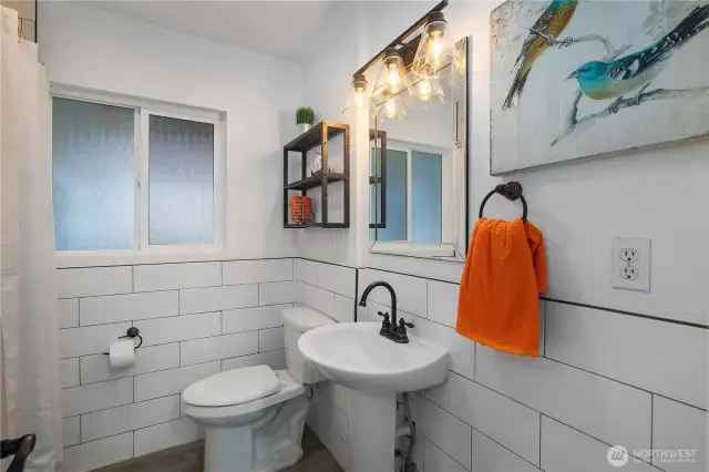 Gorgeous custom tile and modern fixtures in the full bathroom.