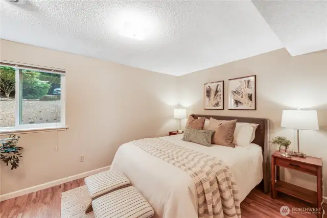 The spacious bedroom features laminate floors and double closets on the opposite wall, which are not shown.