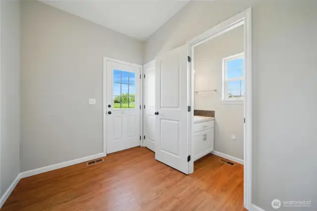 Mudroom with half bath and door to patio