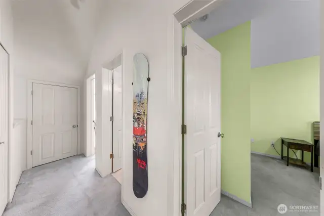 Second floor landing with tall ceilings and windows bring in natural light