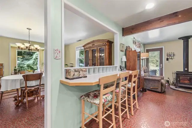 Kitchen eat in area with bar and stools.