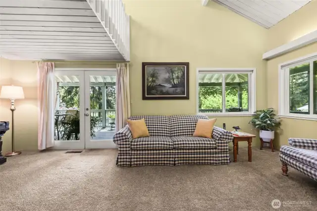 Living room with french doors leading to upper deck.