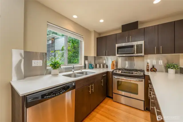 Big window in front of the kitchen sink. Gas cooktop stove and oven. And yes there's a real vent to the exterior.