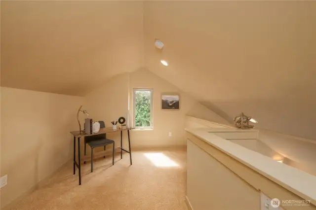 Loft space with a south-facing window. Could be an office, workout space, reading nook, or music space.