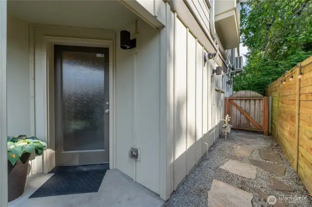 The front door and side path. Fully fenced with a gate.