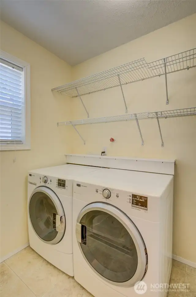 Pass through the primary bathroom and enter into the laundry/utility room.