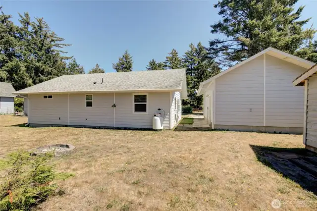 Outside the home again, we take a look at the back yard, which does have a fire pit and storage shed.