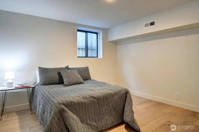Spacious lower level bedroom has a window for additional light.