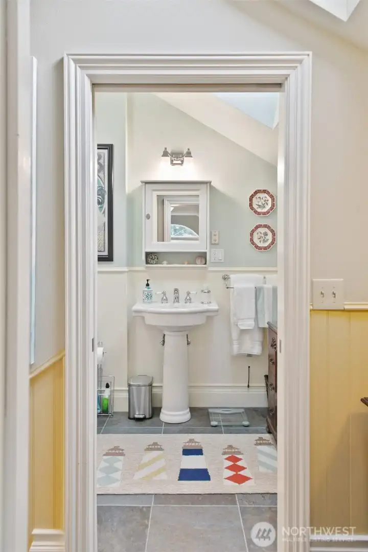 Guest bath across hall from bedroom.