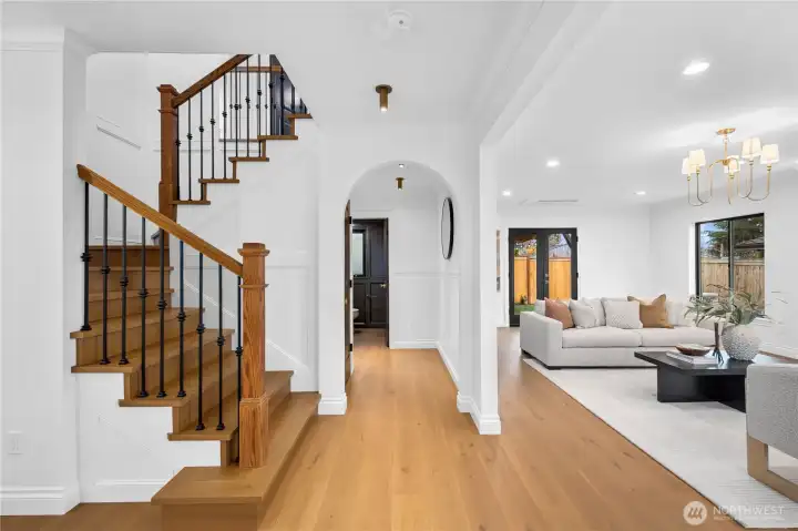 The foyer showcases this remarkably well-designed home... engineered hardwood floors abound; tasteful lighting and high-end finishes throughout with tons of special features!