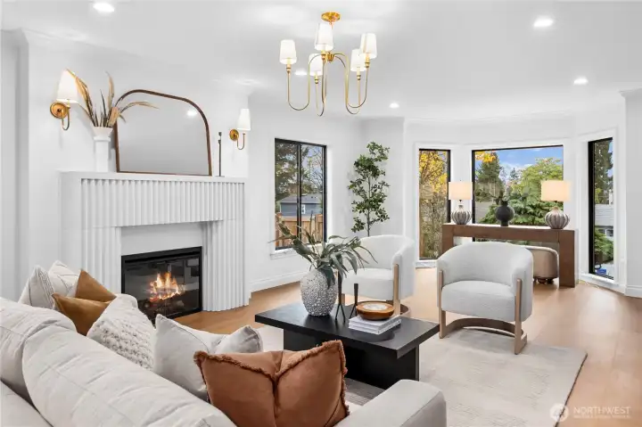 Very spacious living room with a view towards the Puget Sound; a very snazzy stone electric fireplace and stylish gold lighting fixtures...