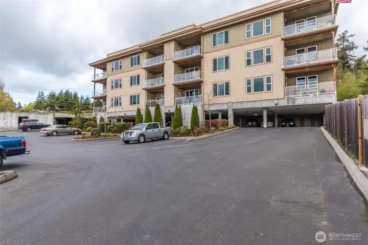 Front of building showing entrance to covered parking garage.