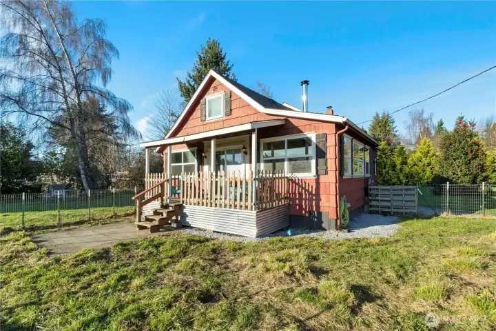 This is the kind of porch buyers imagine themselves actually using. Morning coffee, a quiet moment at the end of the day, or simply watching the light change across the property. On clear days, Mount Rainier comes into view, adding a sense of place that’s hard to replicate. The covered porch extends the living space outdoors, offering year-round comfort and a natural connection between the home and the land. It feels welcoming, grounded, and unhurried, a true first impression that invites you in and encourages you to stay. What a great spot for a covered BBQ area or a hot tub.