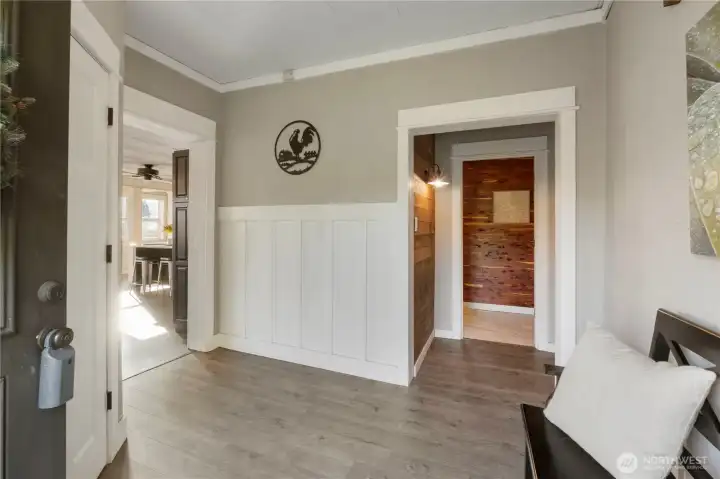 A welcoming entry features new laminate flooring, clean lines, and classic trim. This central hallway naturally guides you toward the bedrooms and updated bath, creating a clear separation between private spaces and the main living areas.