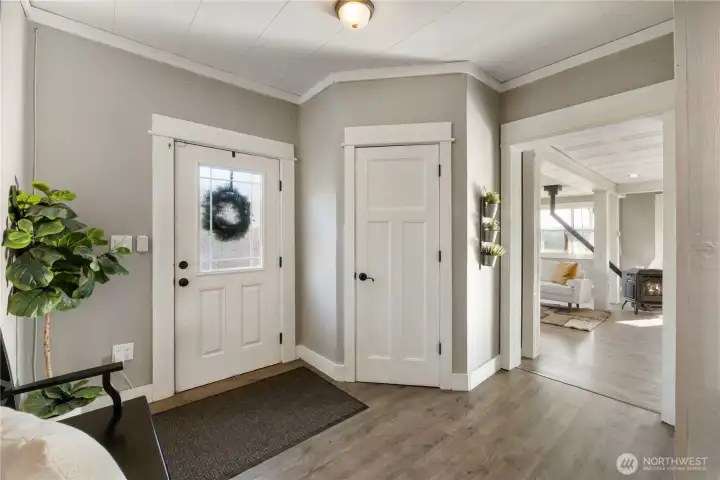From the entry, the home opens naturally into the main living area, drawing you forward with natural light and an easy sense of flow. Wide openings and clear sightlines create a welcoming transition into the heart of the home. Large closet keeps eveything tidy.