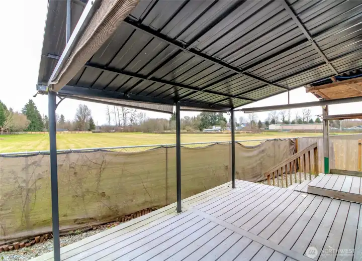 Covered porch overlooks grassy field!