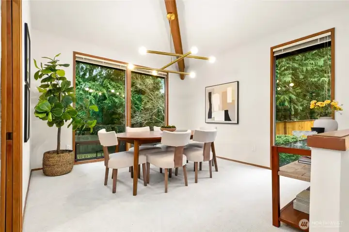 Bright and open dining space framed by expansive windows that bring the surrounding greenery of Sahalee inside.