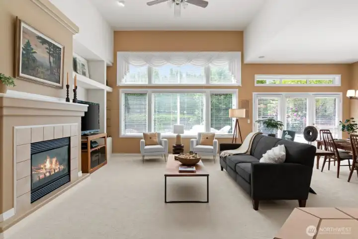 Inviting great room with glass wall and 14' ceilings, illuminating main living areas with natural light.