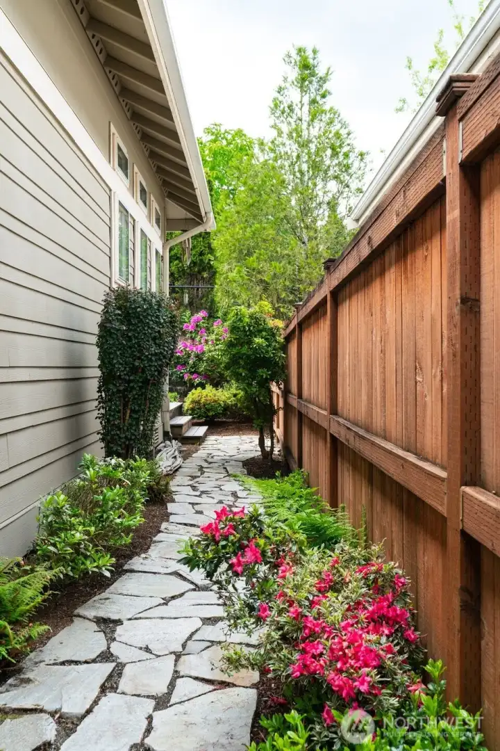 Completely fenced, with side yard pathways leading from front to back of home.