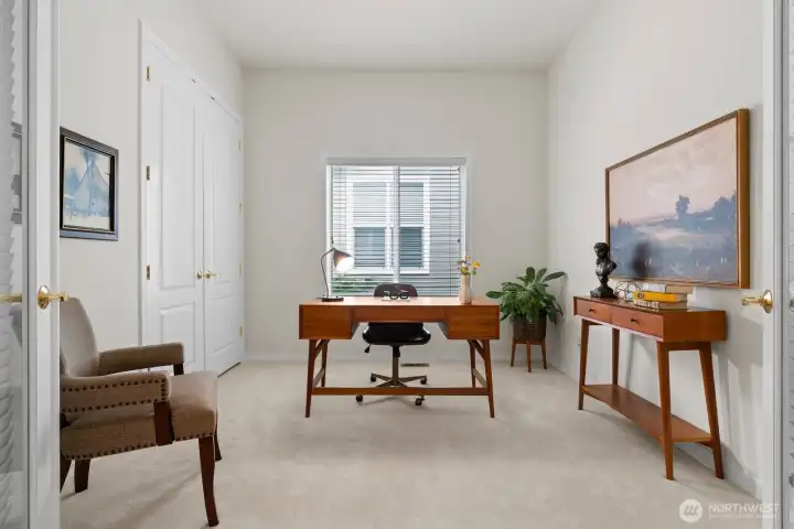 Ideal for a home office, the den with French doors and closet full of custom shelving, is thoughtfully positioned off the entry.