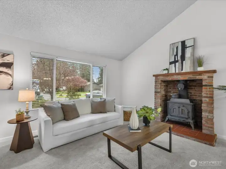 The wood stove set in a beautiful brick surround.