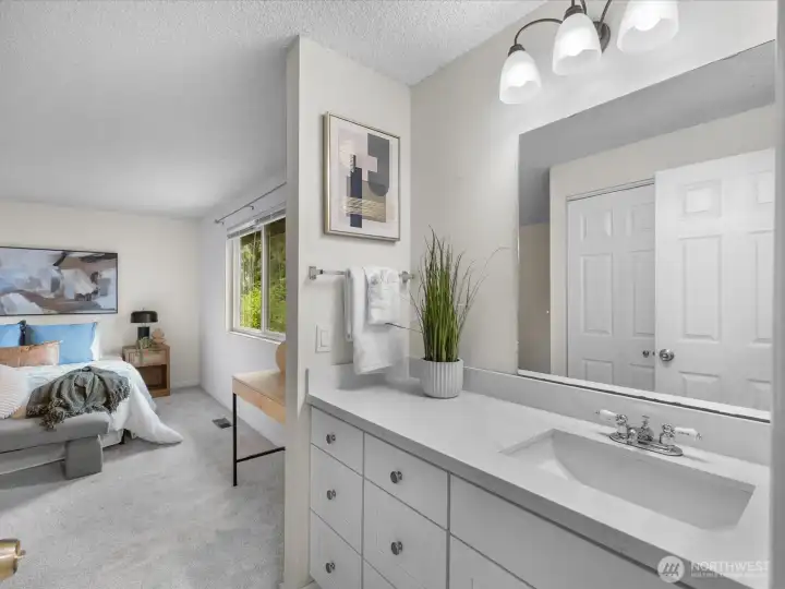 The continental bath provides a large vanity adjacent to the primary bedroom.
