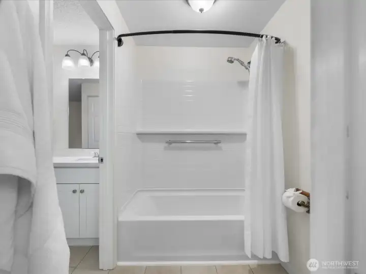 The deep tub has been beautifully updated with a tiled surround.