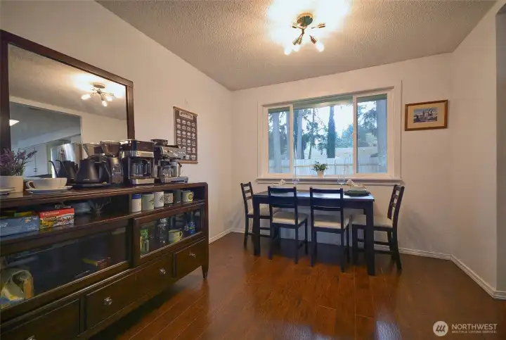 This dining area, currently styled as a coffee station, is conveniently located just off the living room and offers a seamless view into the kitchen.
