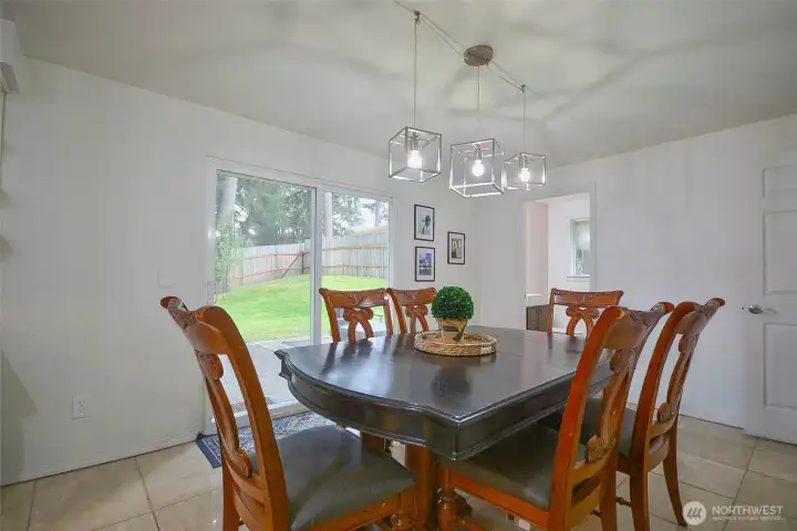 This are is beyond the kitchen and can be formal dining room or den area. Has access to the slider to the back patio, or access to the laundry room, that leads to the great size garage.